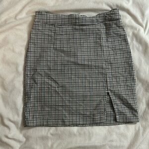 A cute plaid patterned mini skirt with a slit on the front.
